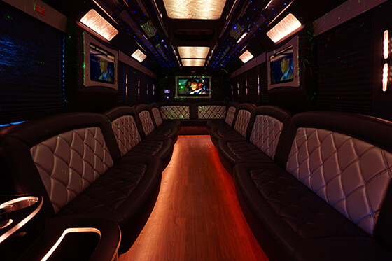 party bus interiors with luxury amenities like wood floors and TVs